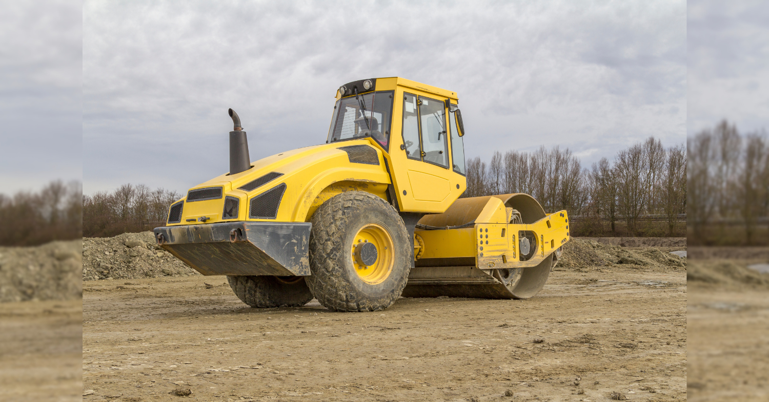 Proof roll testing with a heavy road roller compacting subgrade soil to assess load-bearing capacity