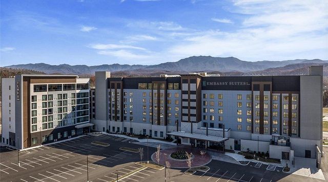 Embassy Suites Tempo by Hilton Pigeon Forge dual brand resort opened 2025 swim up bar Top Golf rooftop bistro 276 rooms Smoky Mountains Tennessee