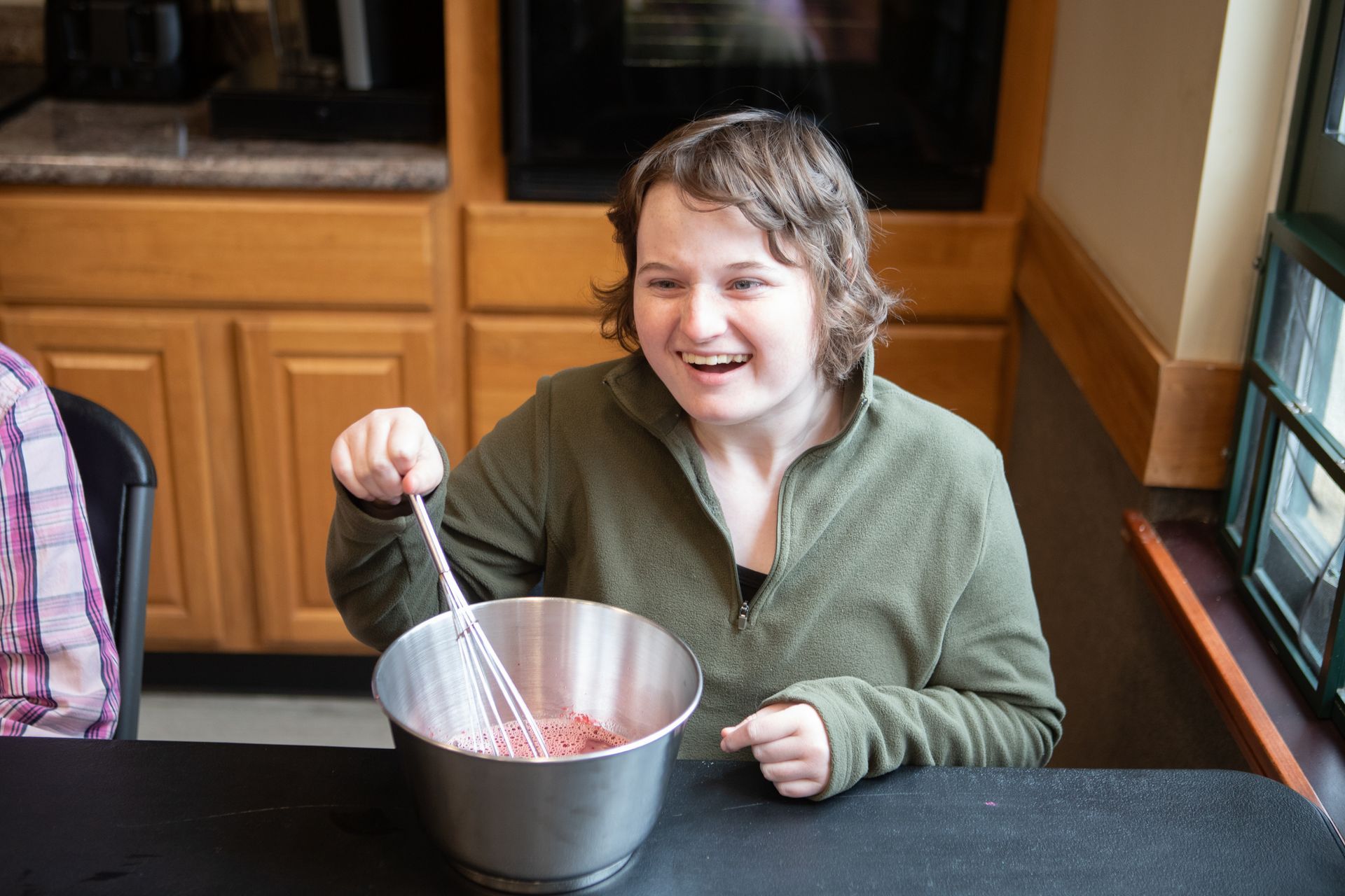 A female supported by BFAIR services preparing food