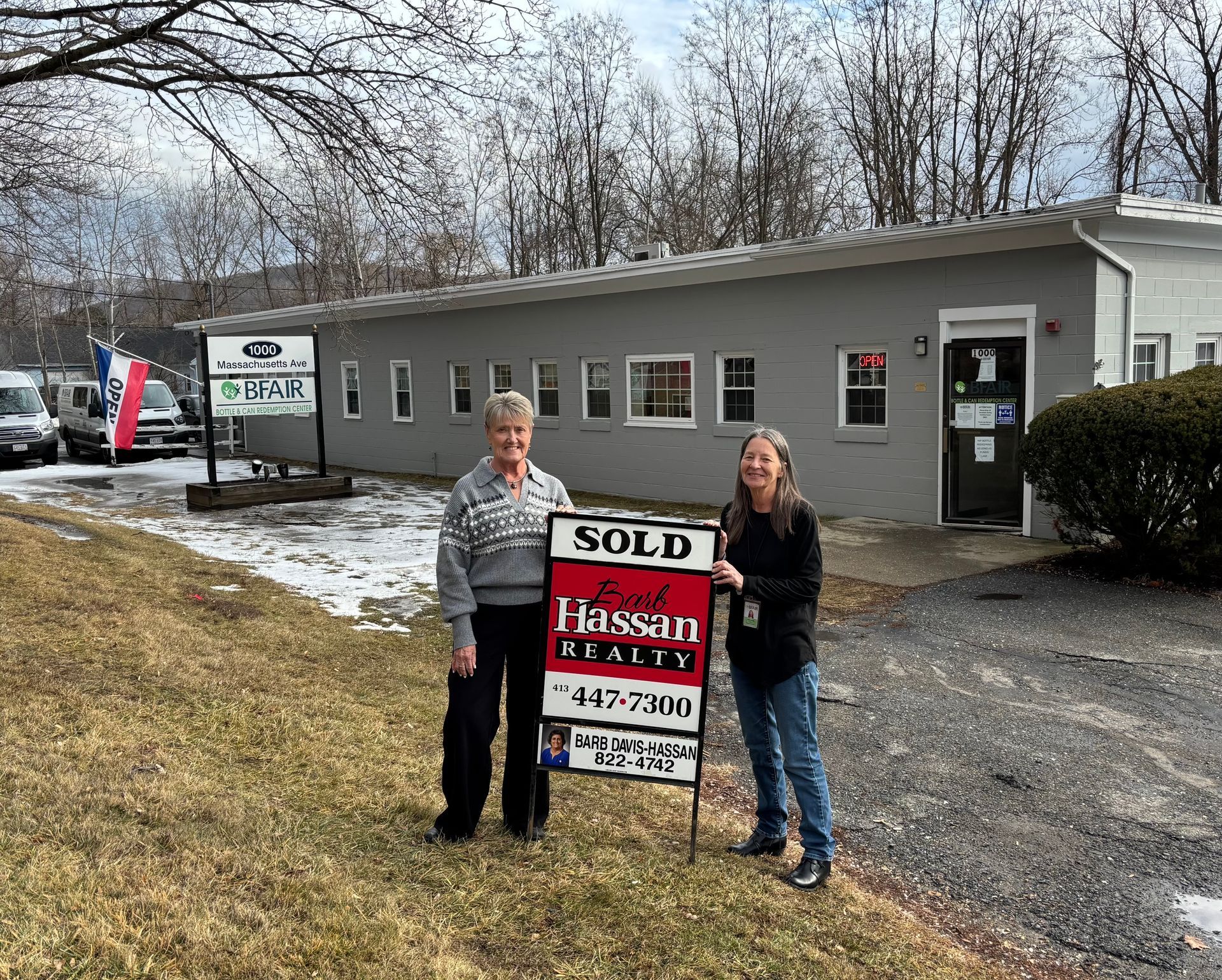 Ethel Altiery, Interim CEO, and Deb Harpin, Director of Employment Services, stand with sold sign