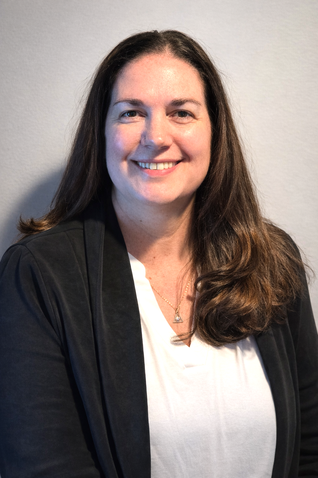 Theresa Denette wearing a black sweater with a white shirt