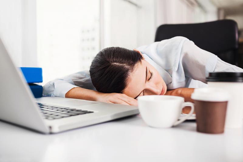 woman sleeping on desk