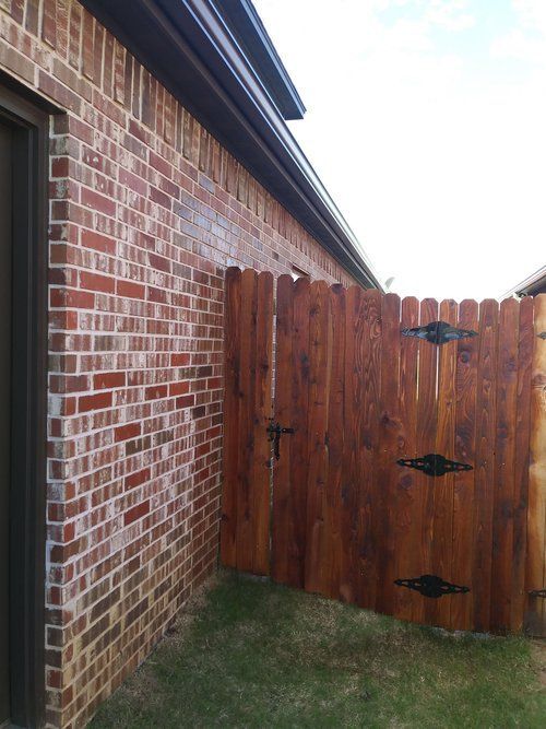 A brick building with a wooden fence in front of it