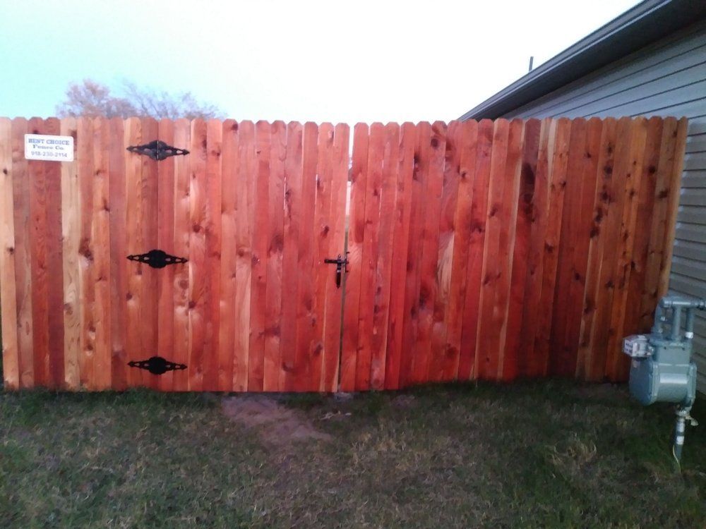 A wooden fence with a sign on it that says 