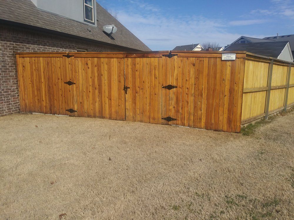 A wooden fence is sitting in front of a house.