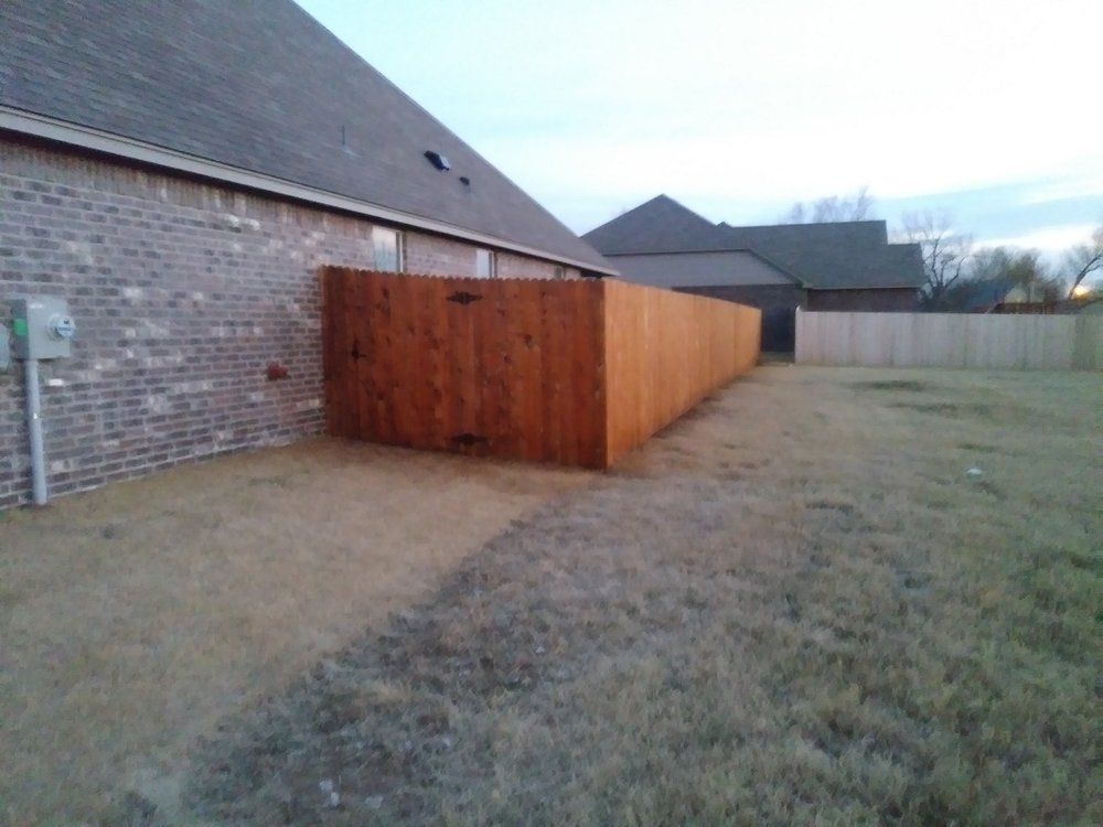 A wooden fence in the backyard of a house