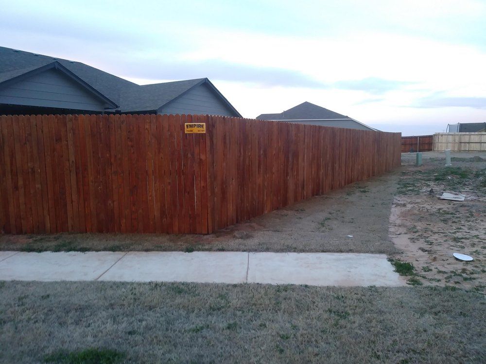 A wooden fence with a sign on it that says caution