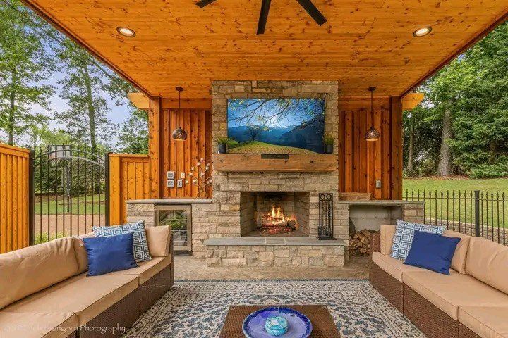A living room with a fireplace and a flat screen tv.