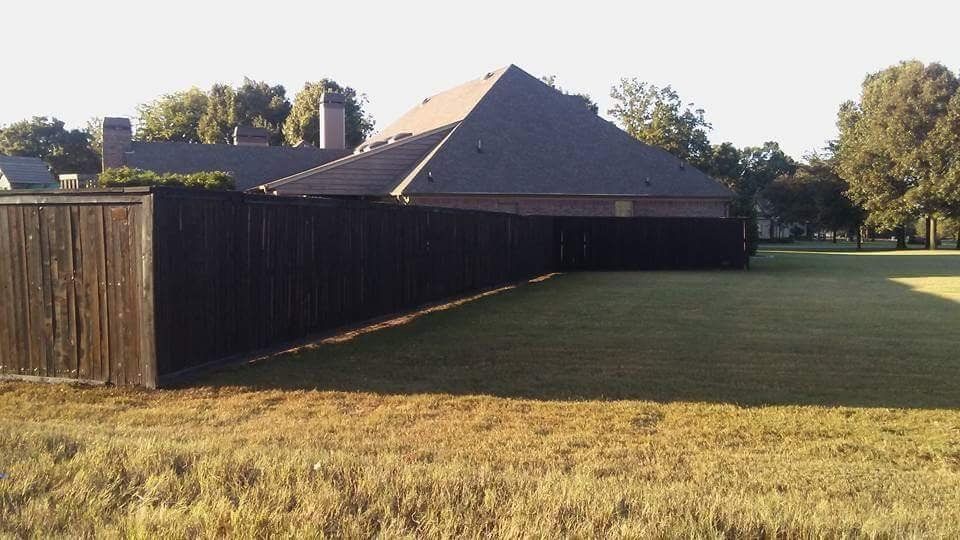 A house with a black fence in front of it