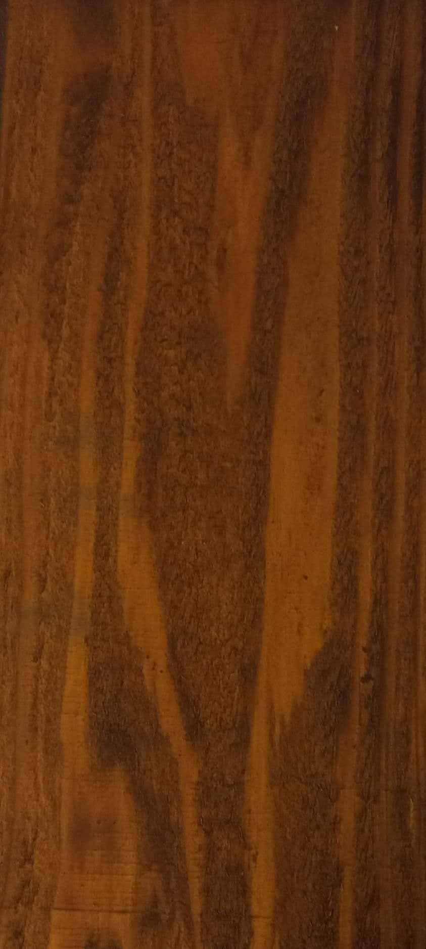 A close up of a piece of wood showing the grain and texture.