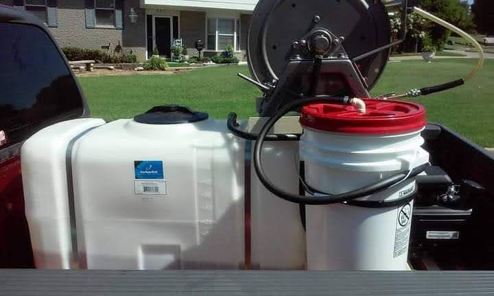 A truck with a tank and bucket attached to it