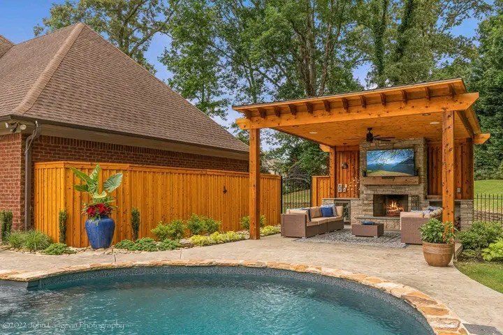 There is a swimming pool in the backyard of a house.