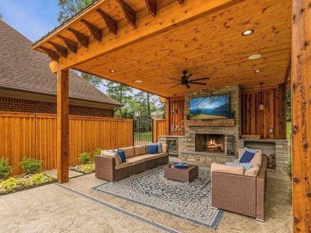 A living room with a fireplace and a flat screen tv.