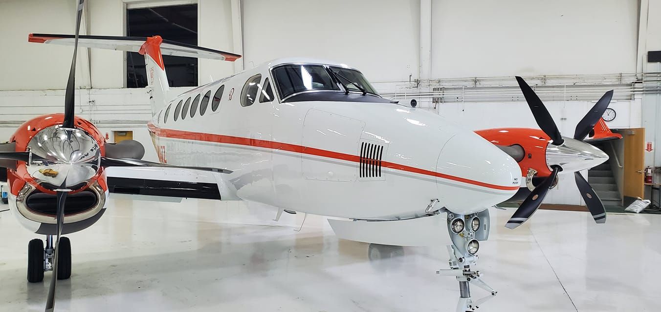 A small propeller plane is parked in a hangar.