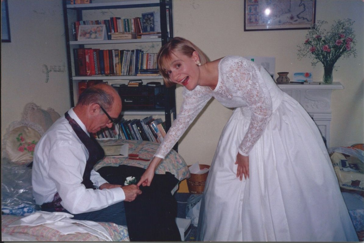 Bride getting ready for wedding, with father.