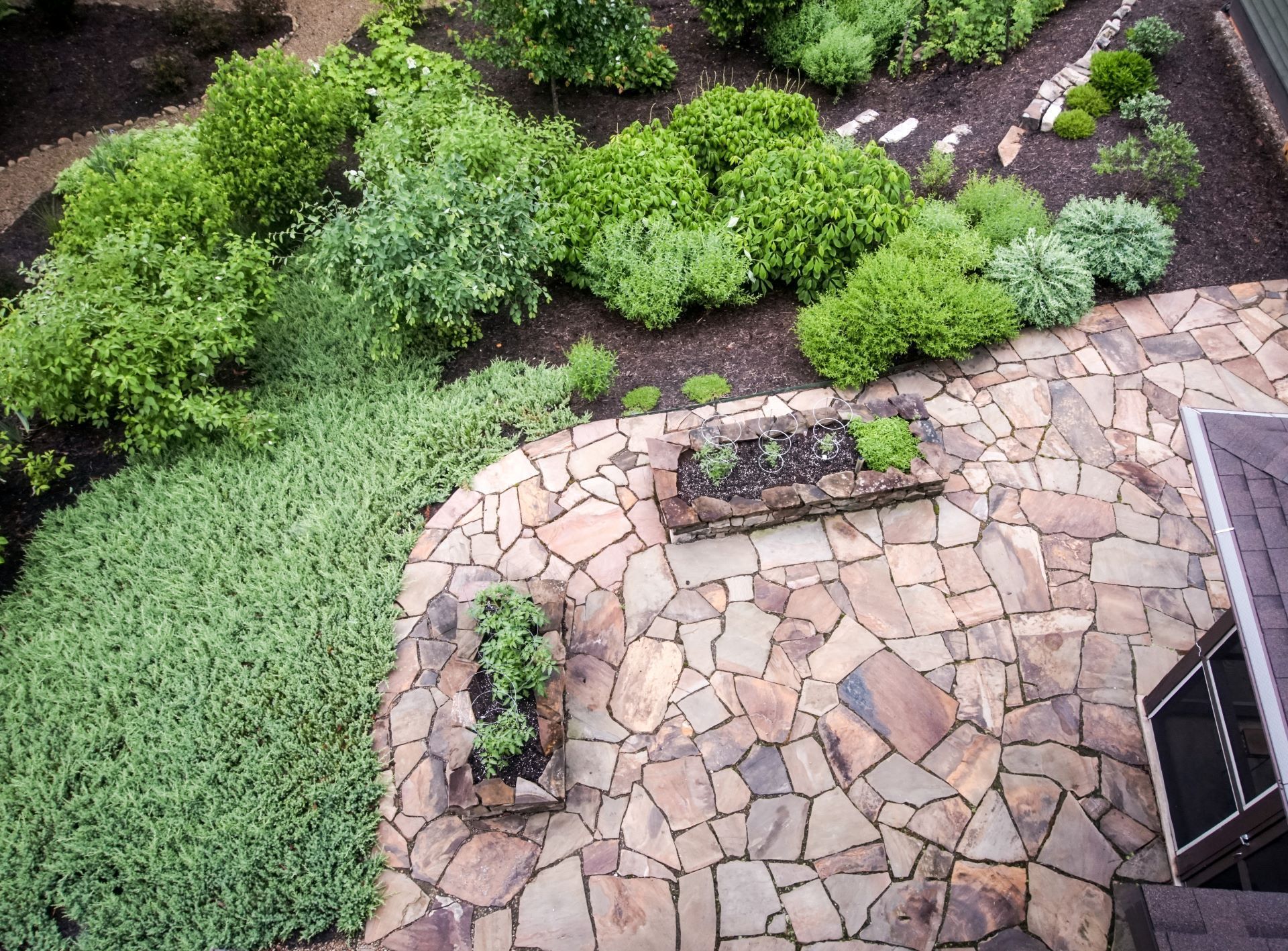 bird's eye view photo of a garden and patio with flagstone