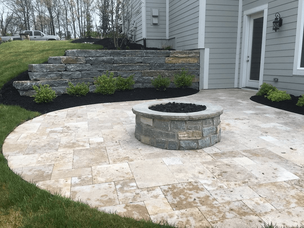 fresh patio design by Grand River Stone with a fire pit and retaining wall
