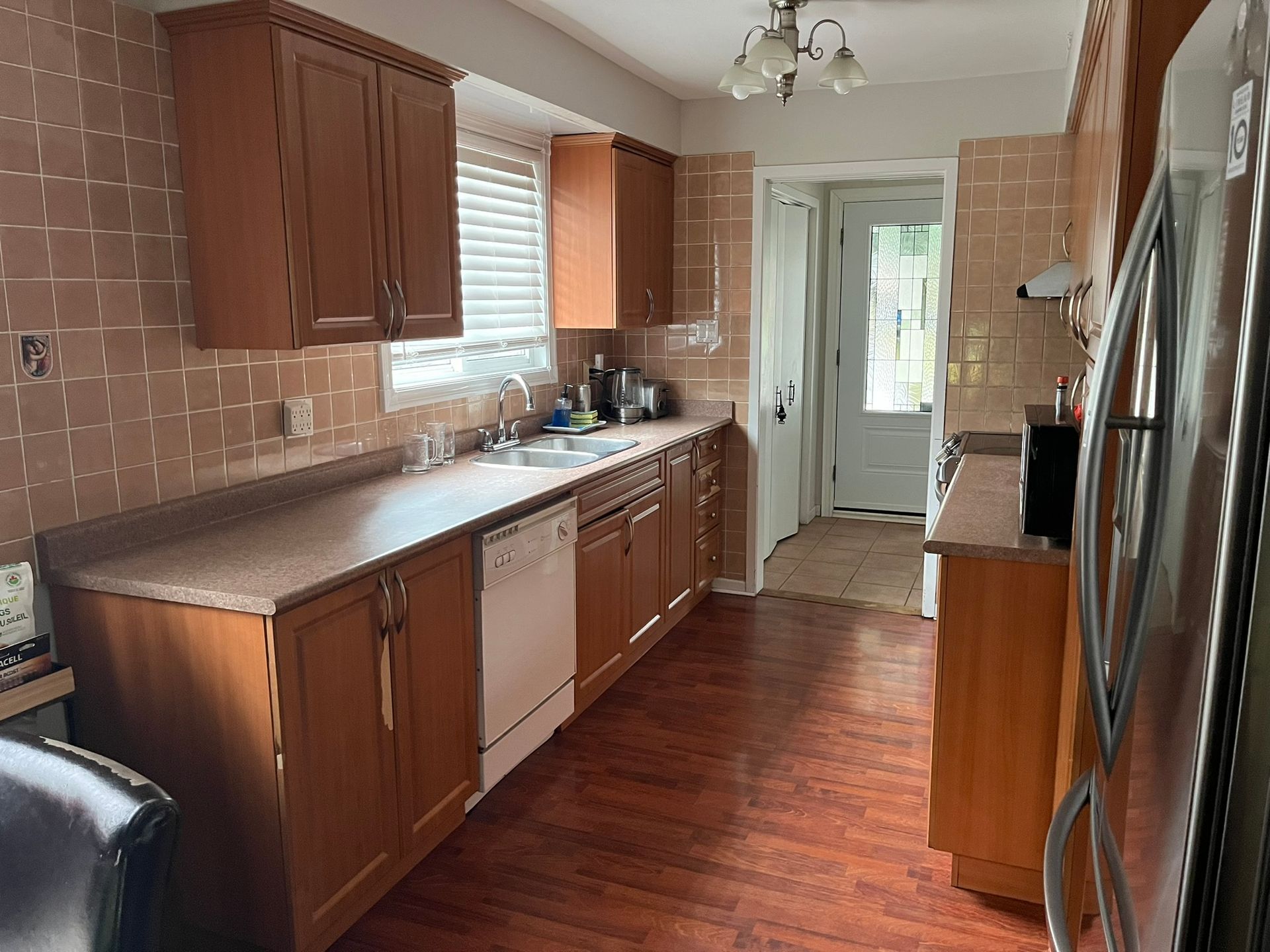 A kitchen with wooden cabinets and stainless steel appliances