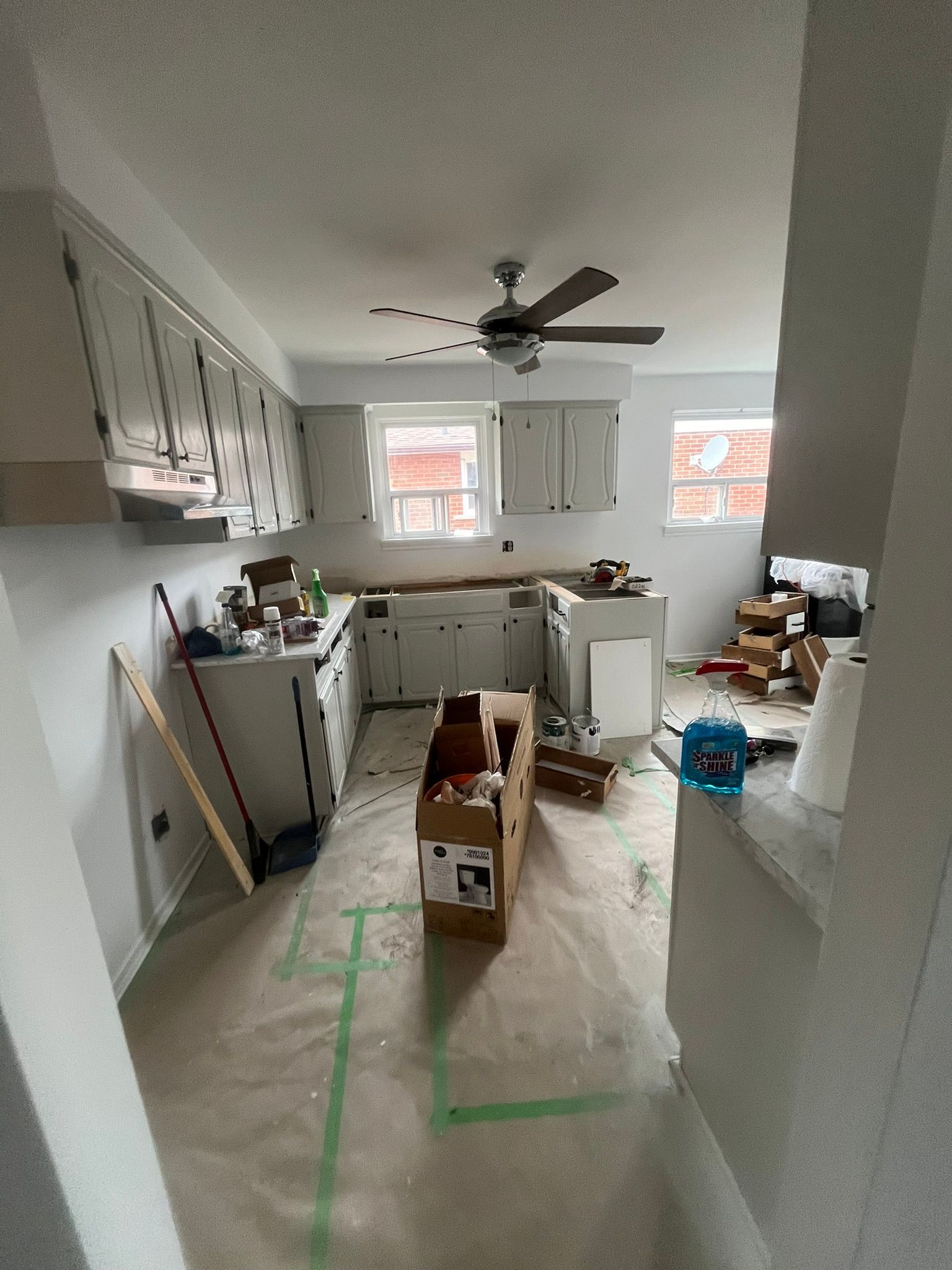 A long hallway with a sliding glass door leading to a balcony.