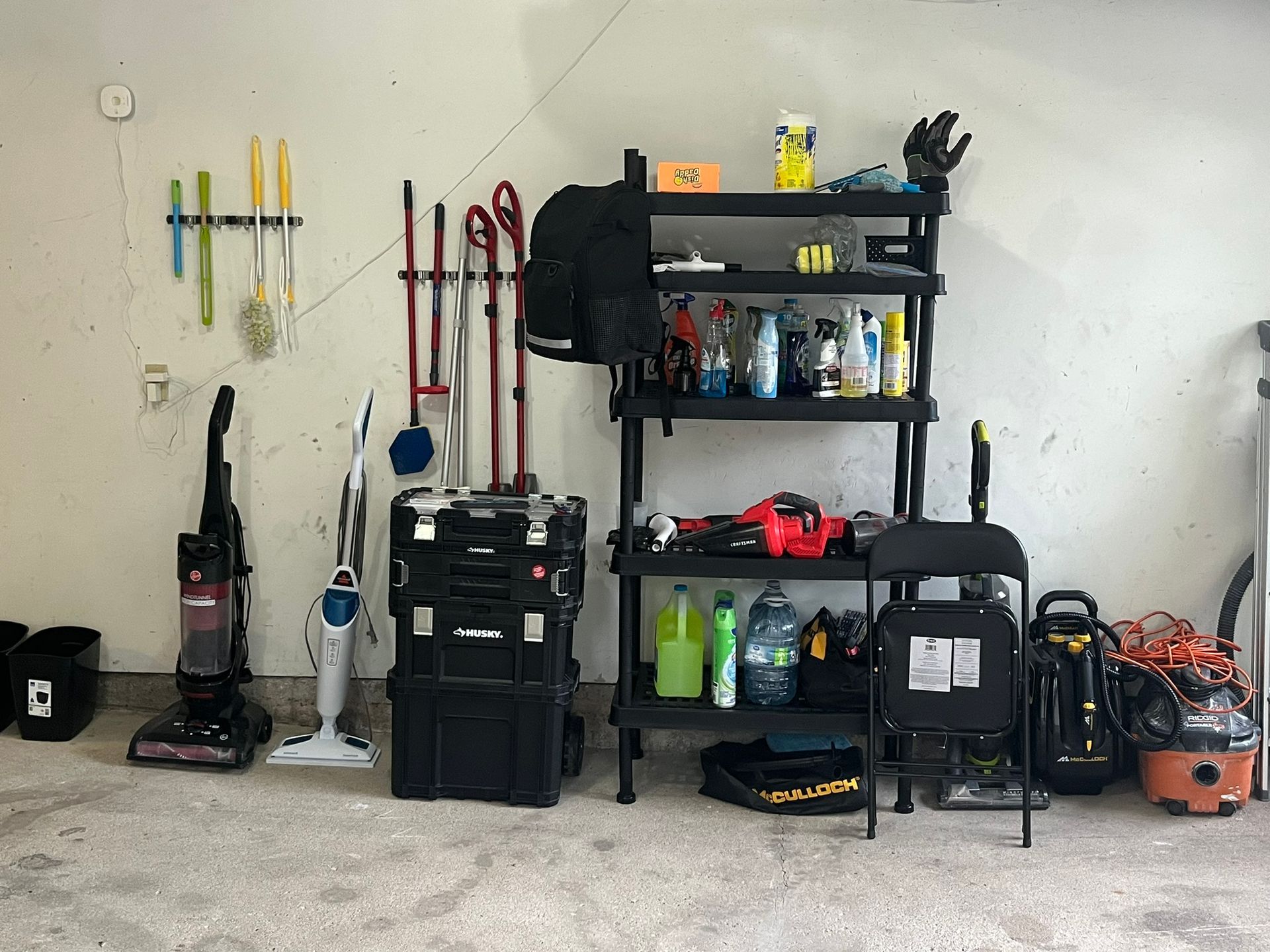 A living room with a table , chairs , and a television.