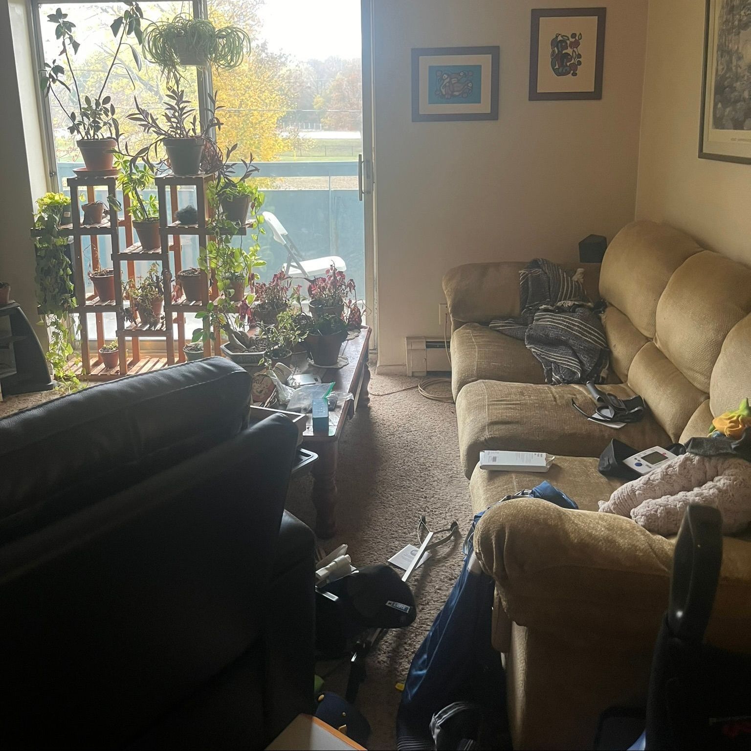 A living room with a couch , chairs , and a sliding glass door.