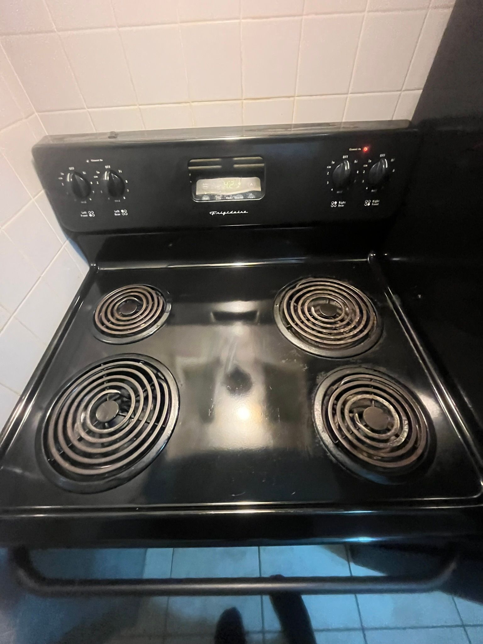 A black stove top oven with four burners is in a kitchen.