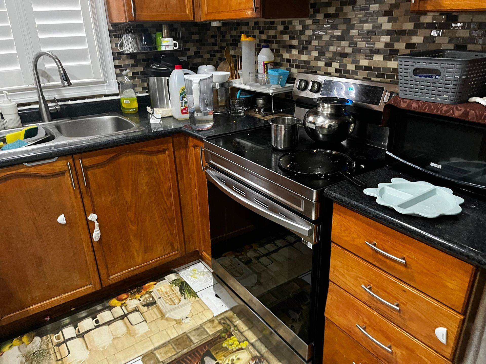 A kitchen with stainless steel appliances and wooden cabinets