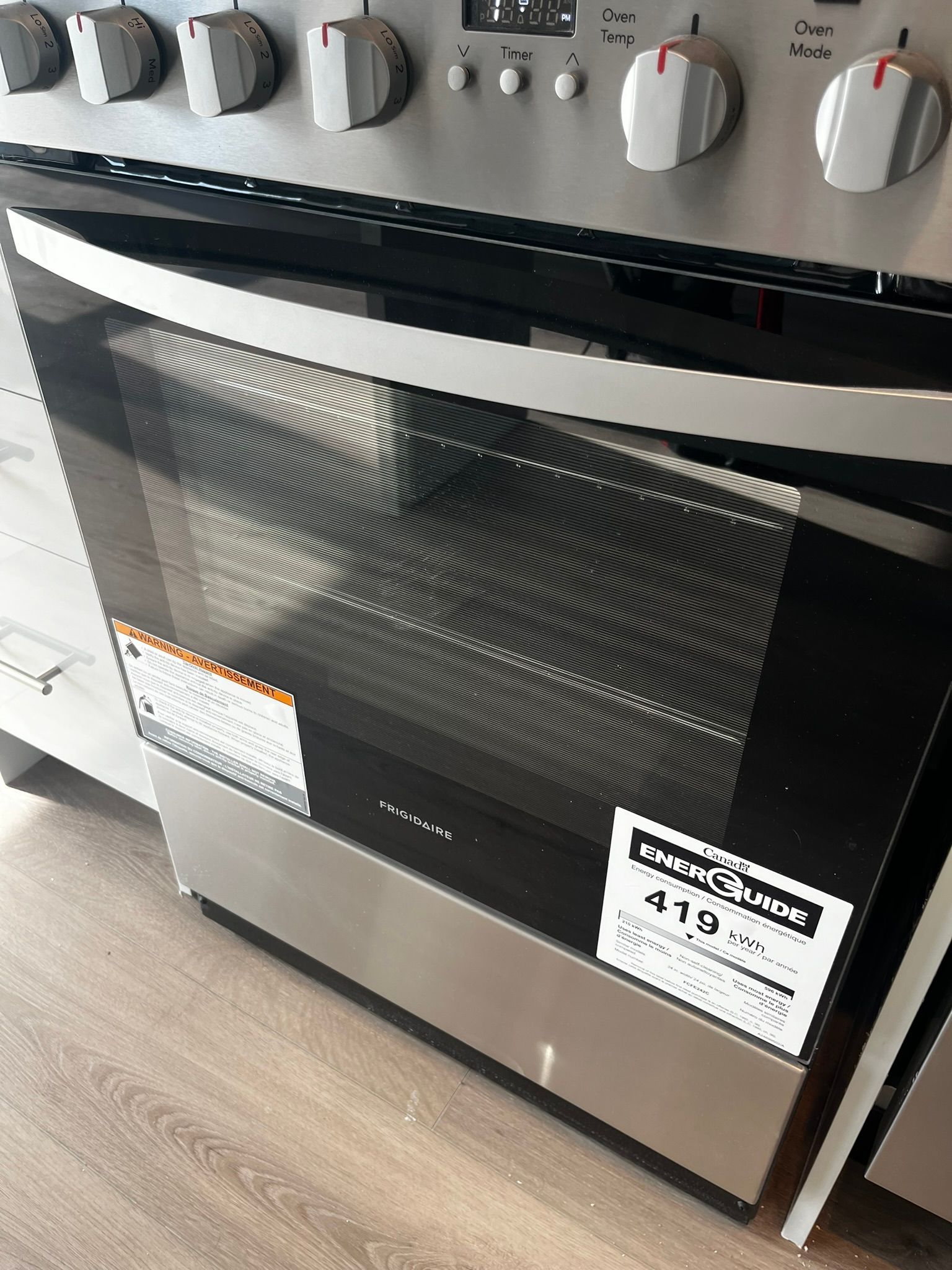 A close up of a stove top oven with a black glass top