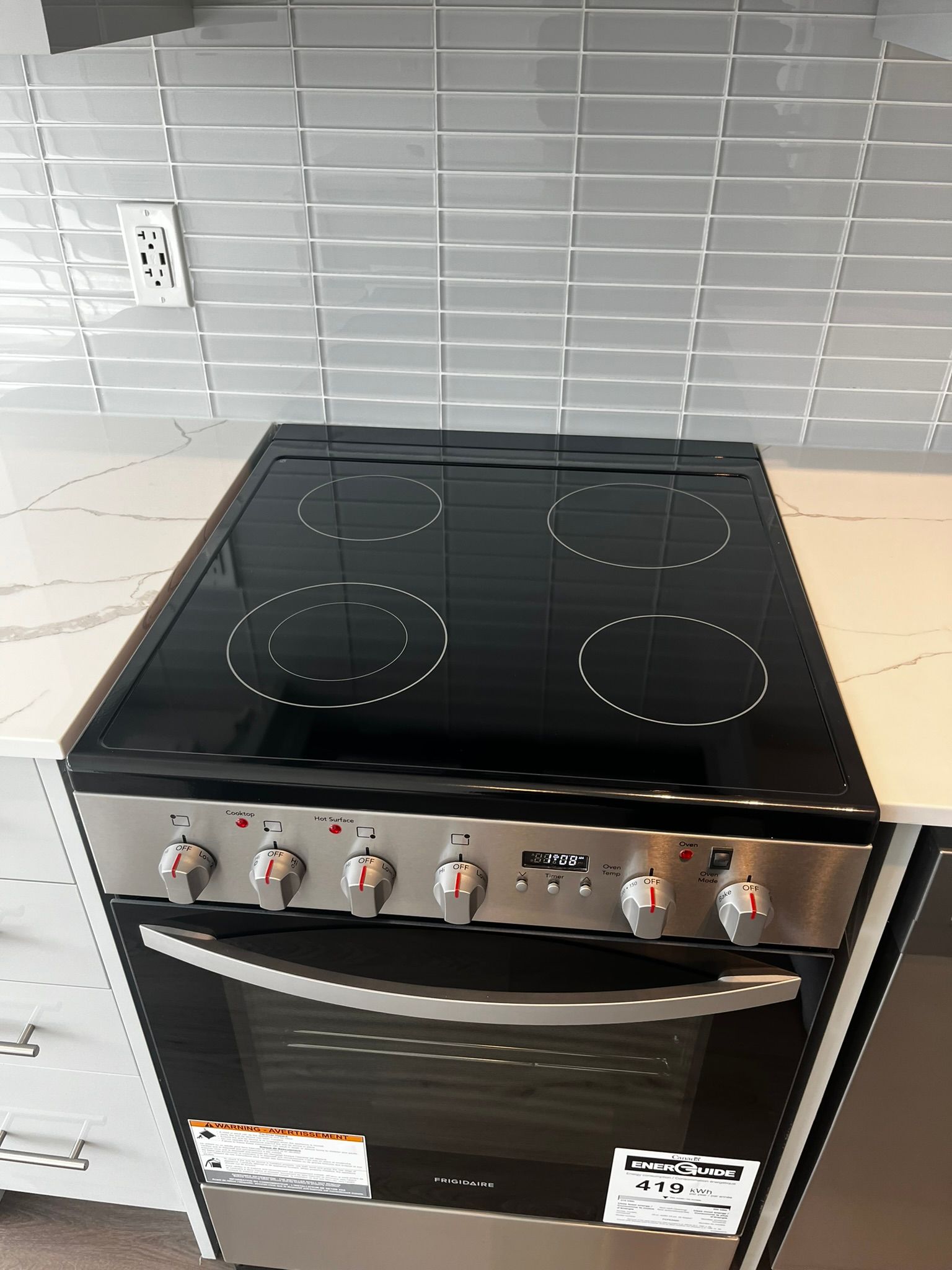 A stove top oven is sitting on top of a counter in a kitchen.