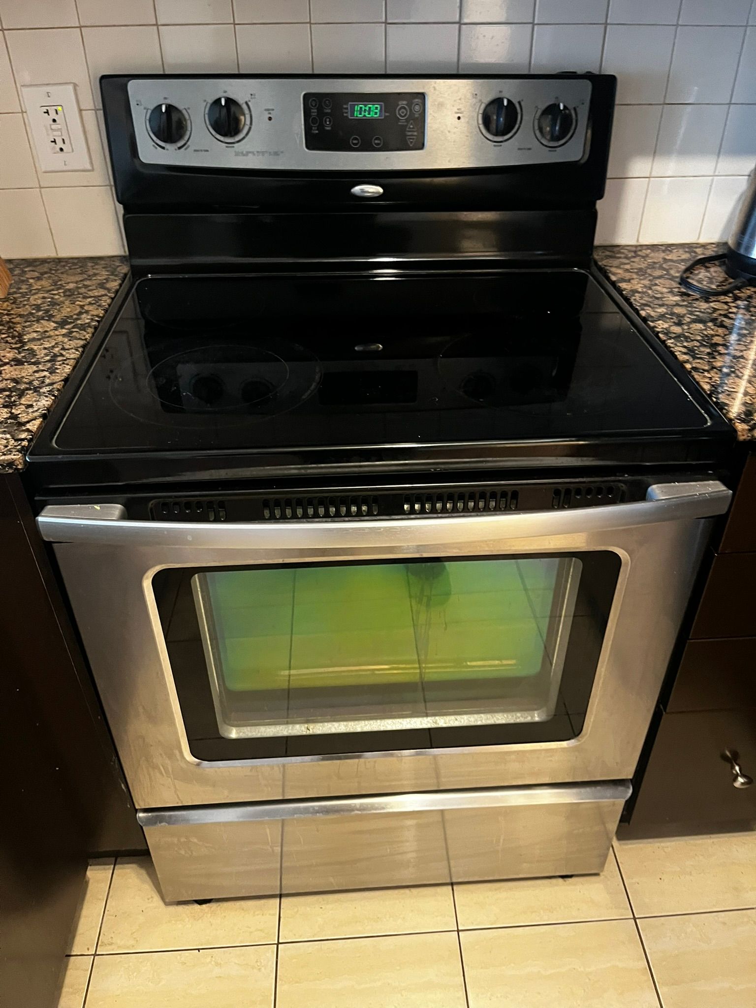 A kitchen with a refrigerator , stove , microwave and sink.