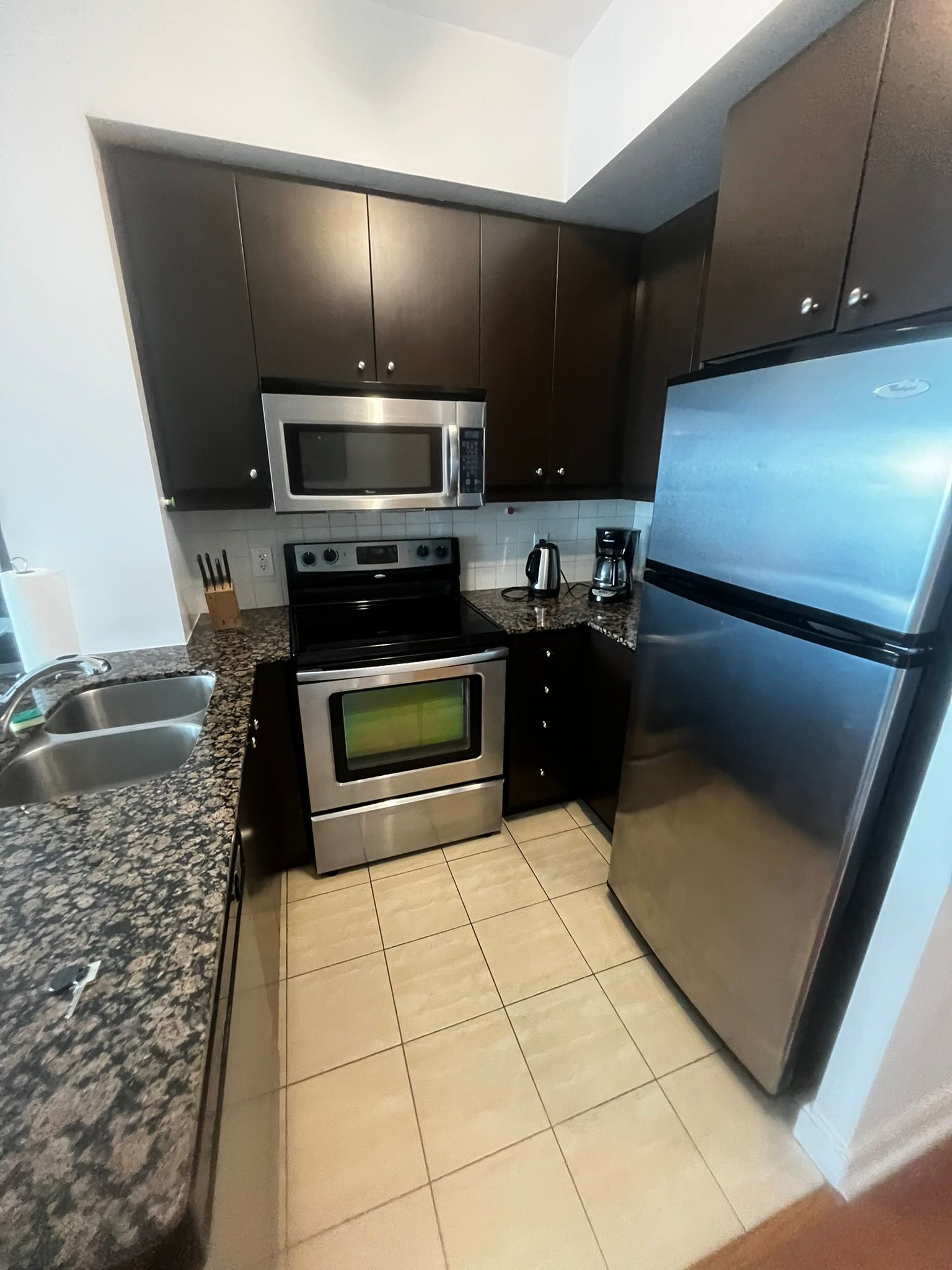 A kitchen with stainless steel appliances and granite counter tops