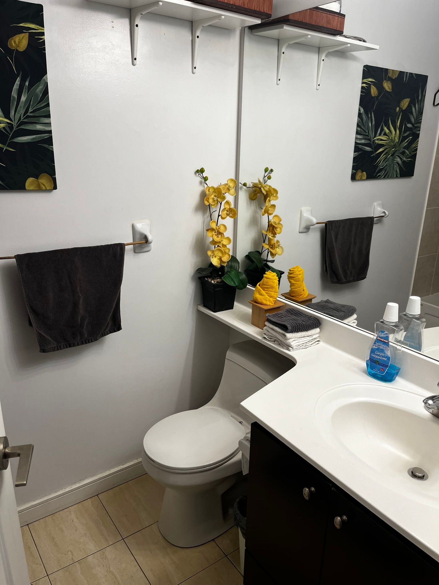 A bathroom with a toilet , sink and mirror