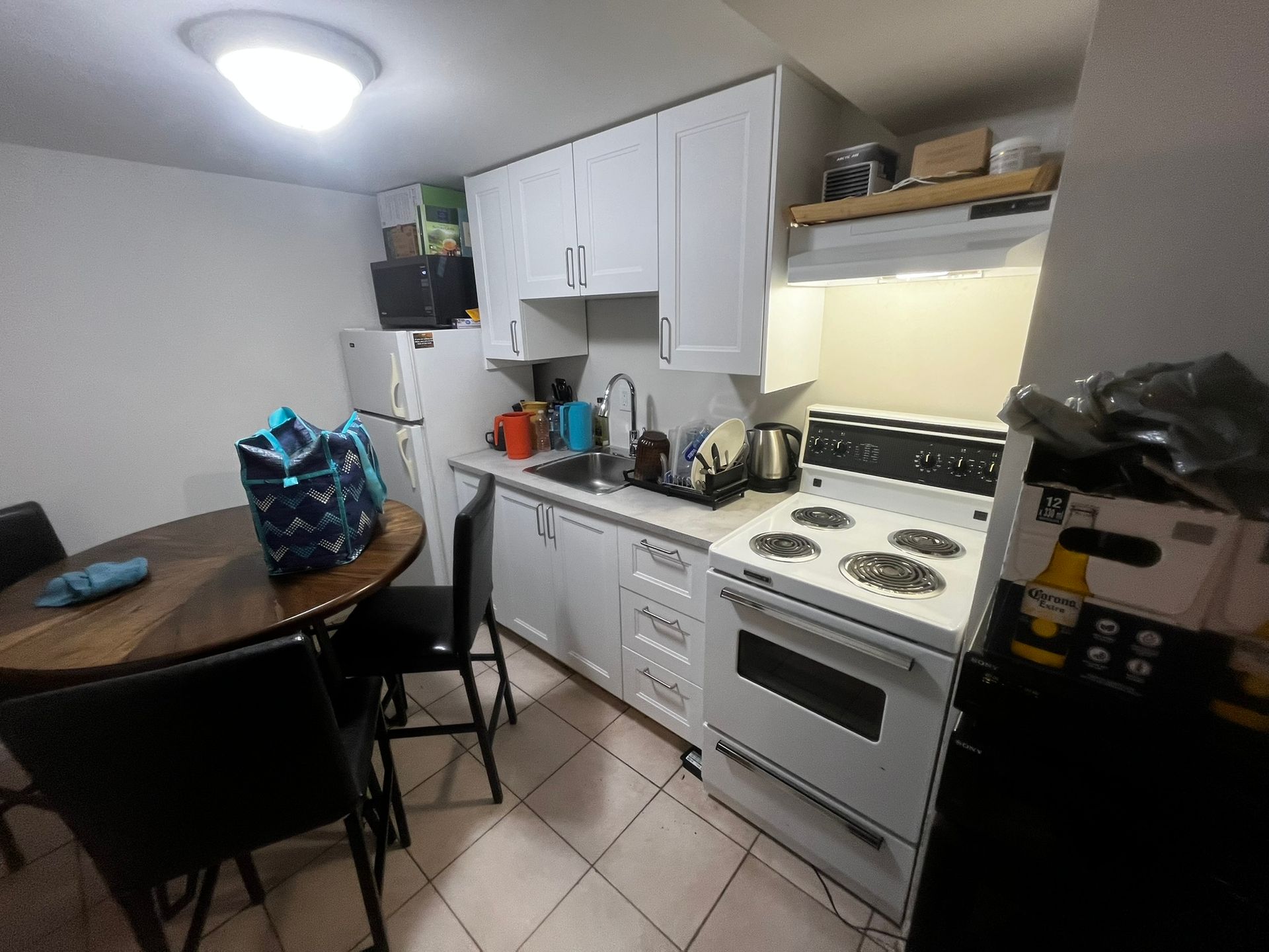 A kitchen with a table and chairs and a stove.