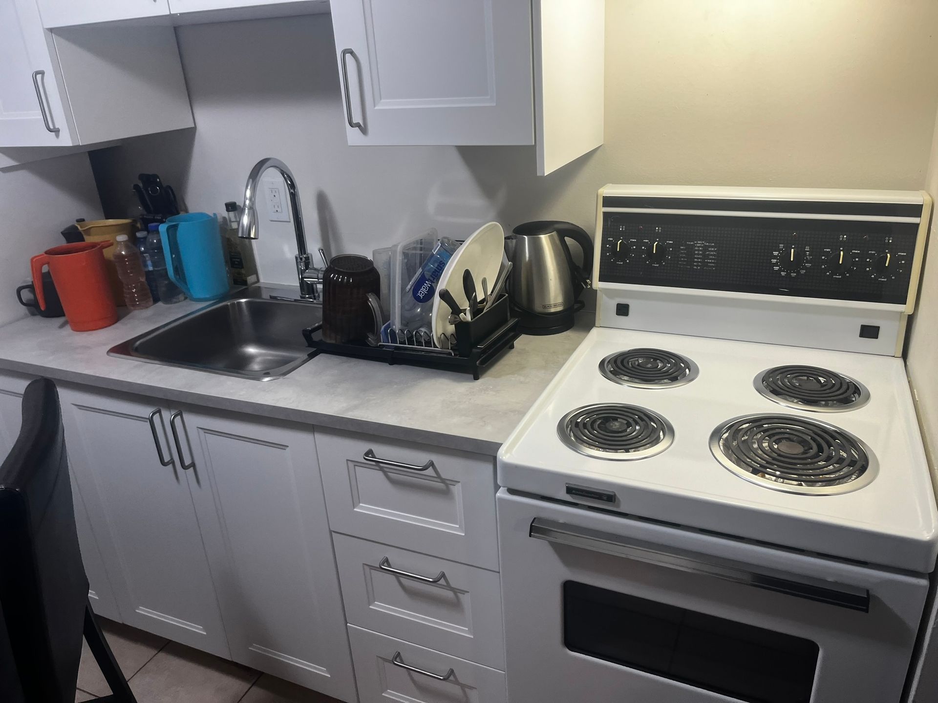 A kitchen with a table and chairs and a refrigerator.