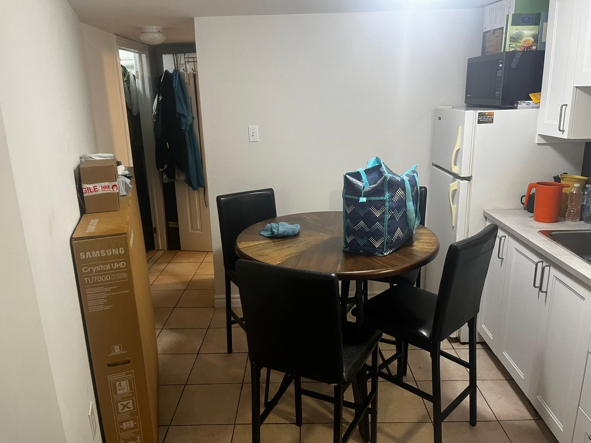 A kitchen with a table and chairs in it
