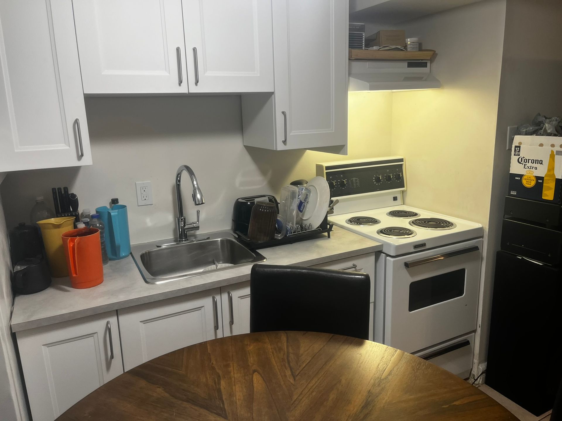 A kitchen with a stove a sink and a table