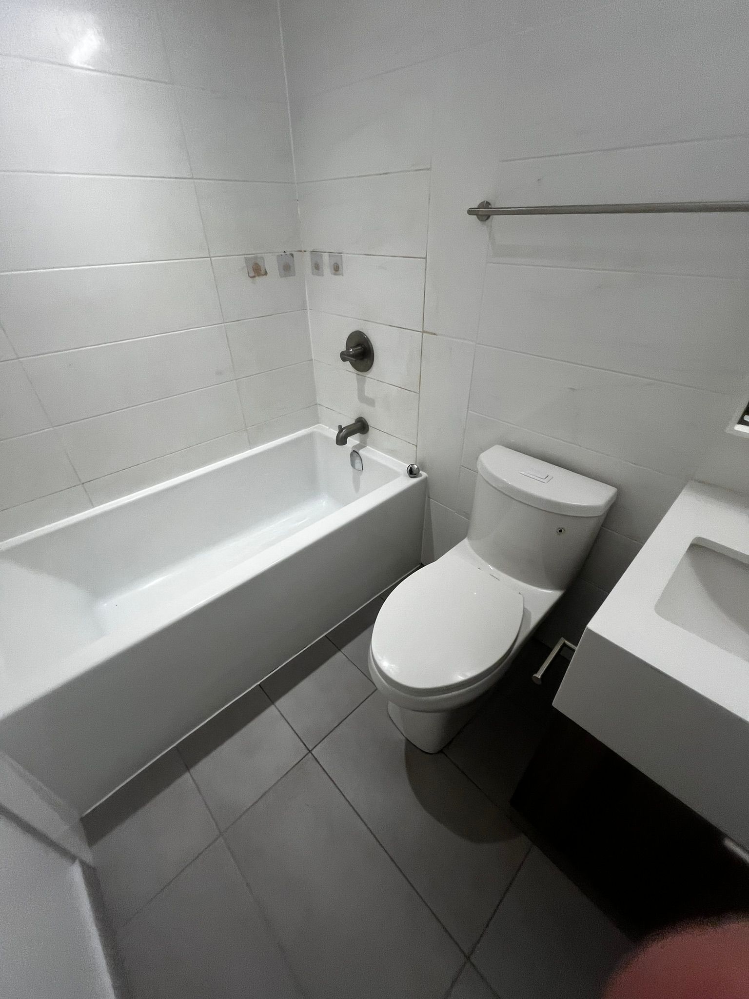 A bathroom with a toilet , sink and bathtub