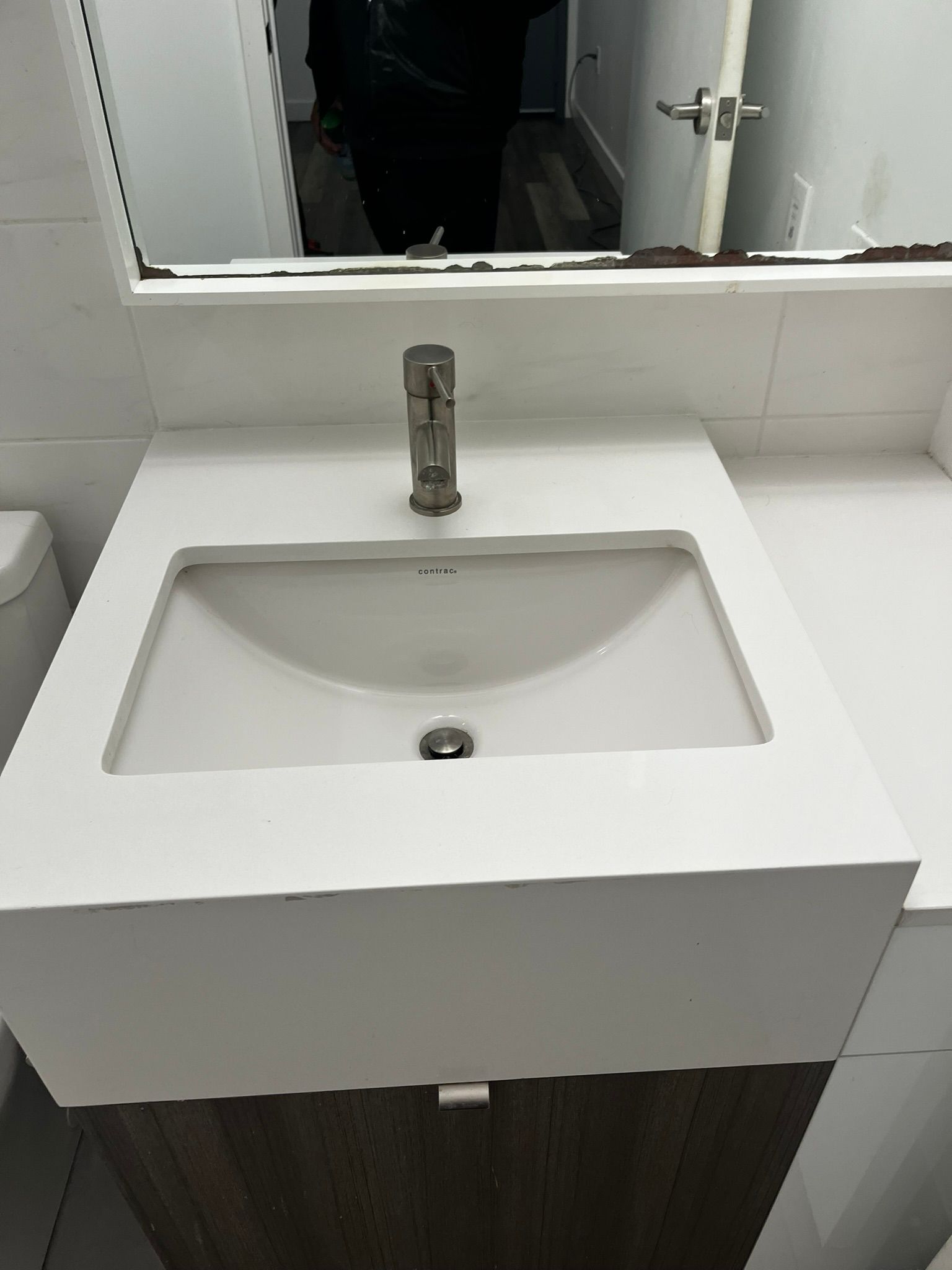 A bathroom sink with a faucet and a mirror.