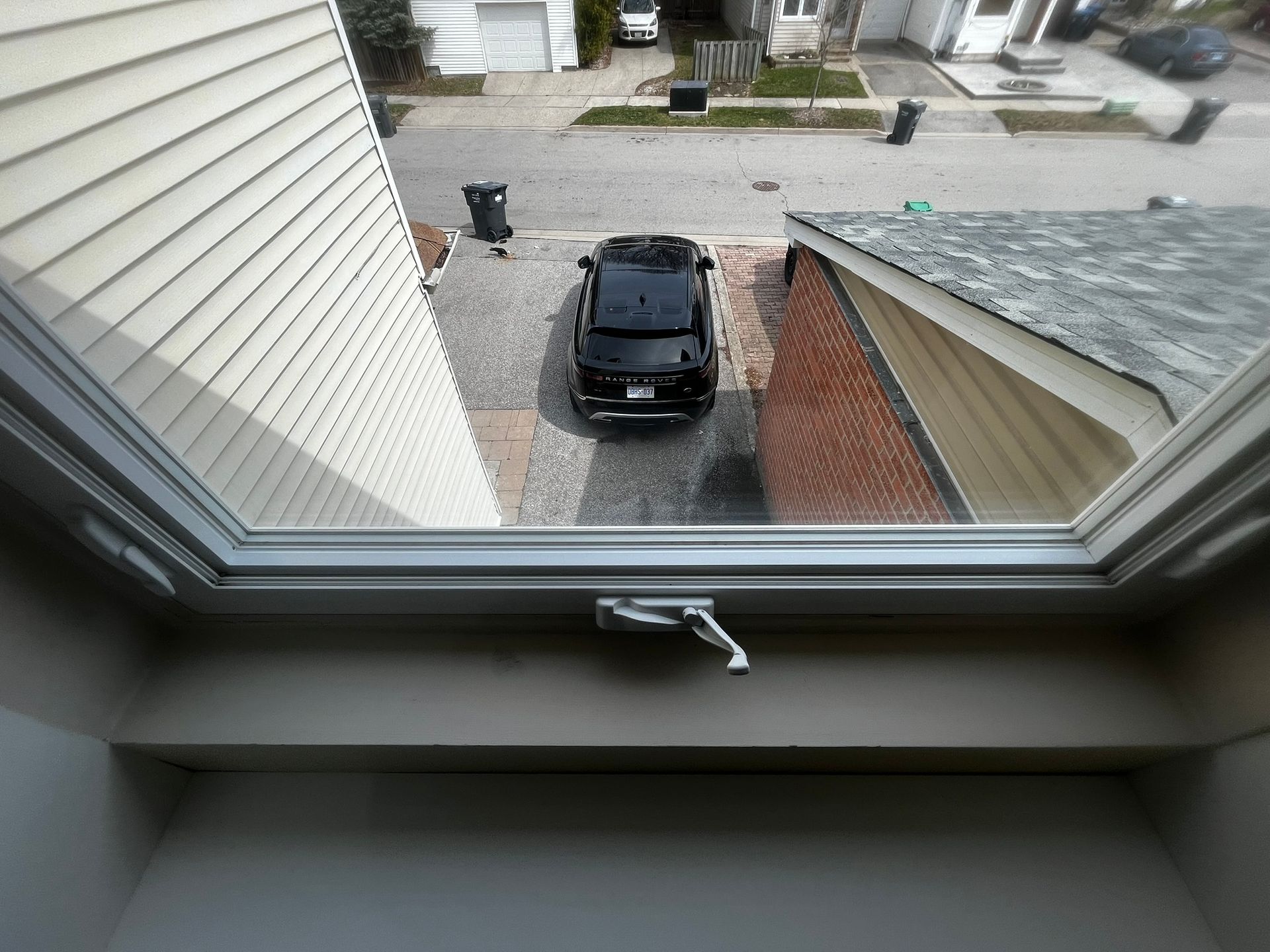 A car is parked in the driveway of a house