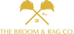 A logo for the broom and rag co. with two crossed brooms