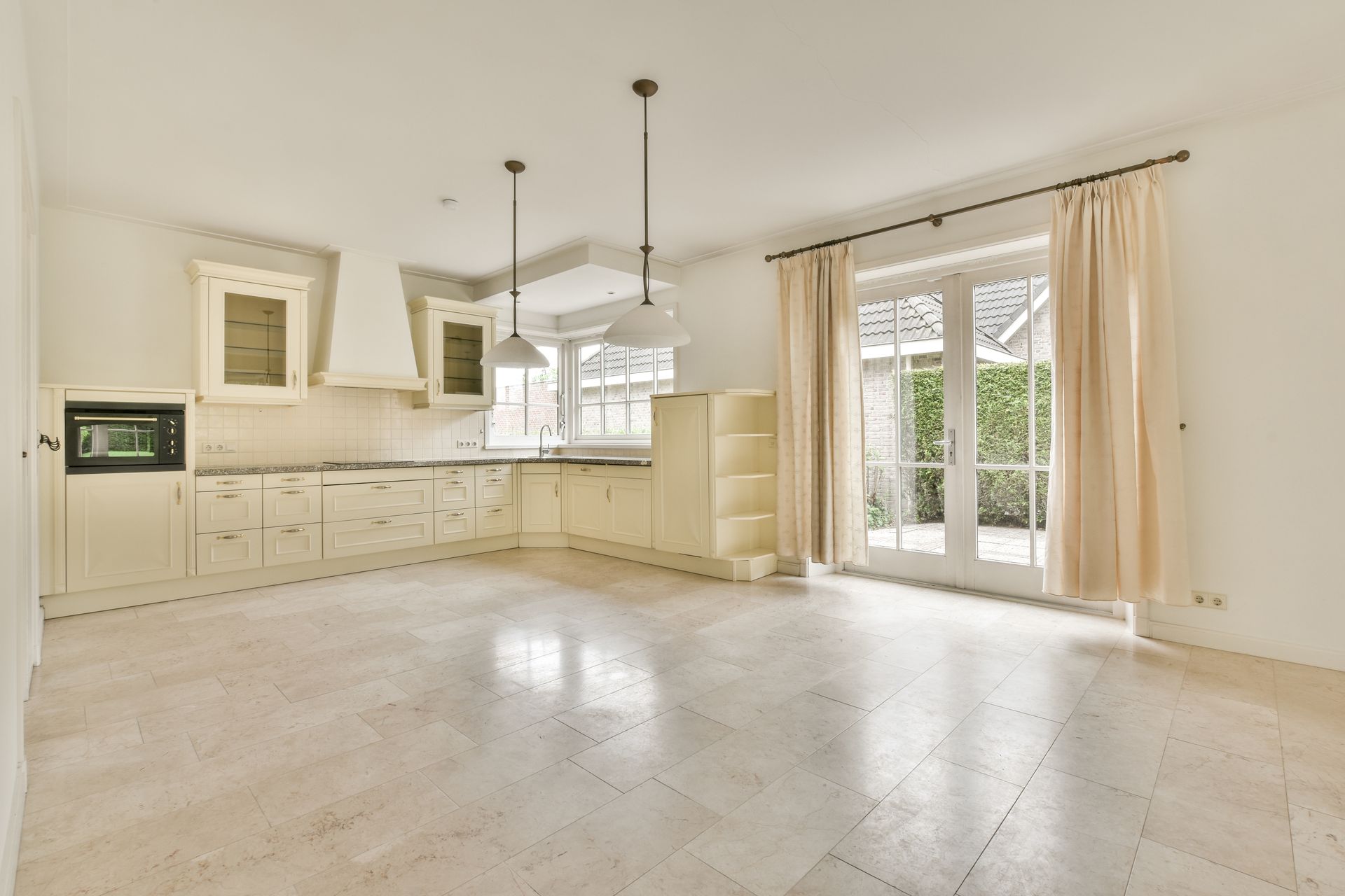 Living room: brown recliner sofa, gray patterned rug, glass coffee table, armchair, and a city view.