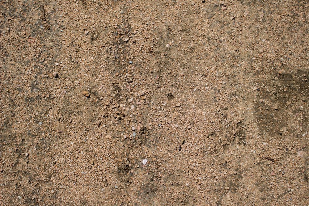 Close-up of Gritty, Tan Dirt Surface With Darker Patches — Australian Sandstone Products In Canungra, QLD