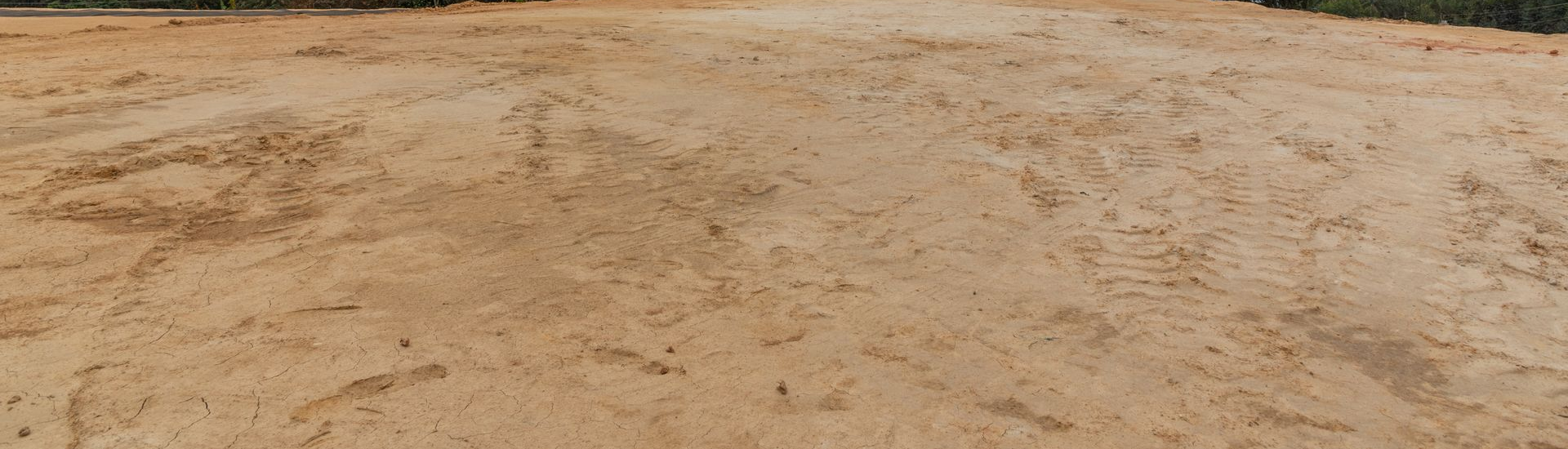 A Dry, Brown, Dirt Field With a Small Line of Green Trees in the Background — Australian Sandstone Products In Warwick, QLD