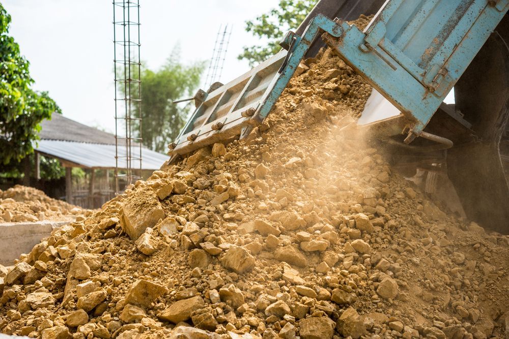 Dump Truck Unloading Brown Dirt — Australian Sandstone Products In Toowoomba, QLD