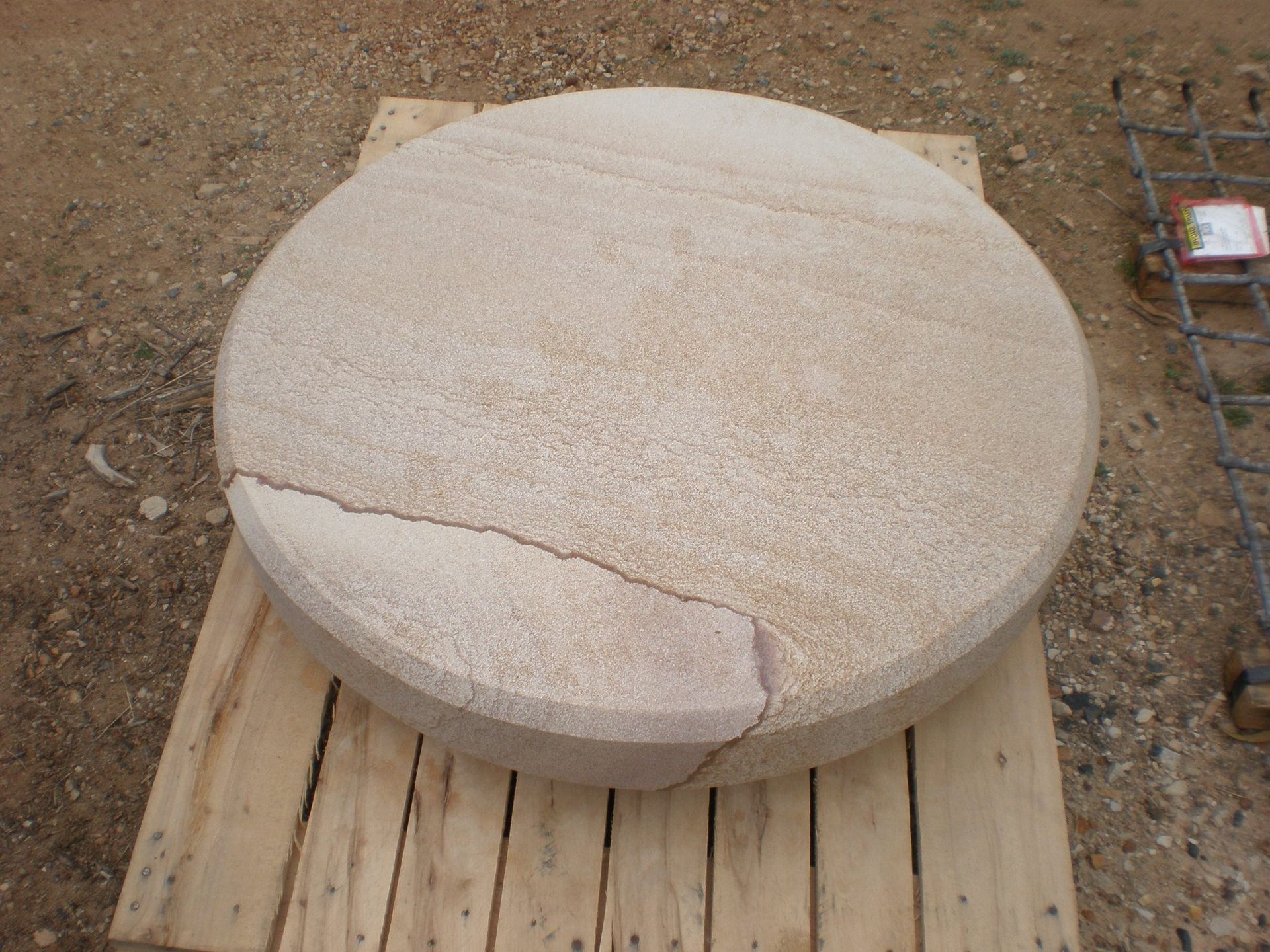 Circular Sandstone Stone on Wooden Pallet, Cracked on One Side — Australian Sandstone Products In Tweed Heads, QLD