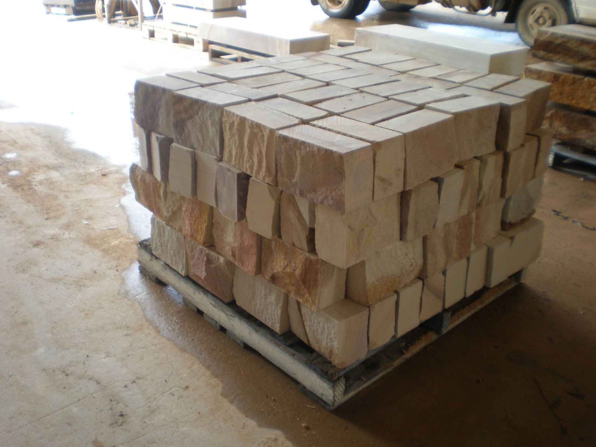 Pallet of Beige Sandstone Blocks Stacked on a Concrete Floor — Australian Sandstone Products In Helidon, QLD