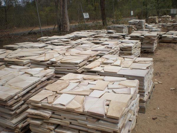 Stacks of Irregularly Shaped, Light-colored Flagstone — Australian Sandstone Products In Helidon, QLD