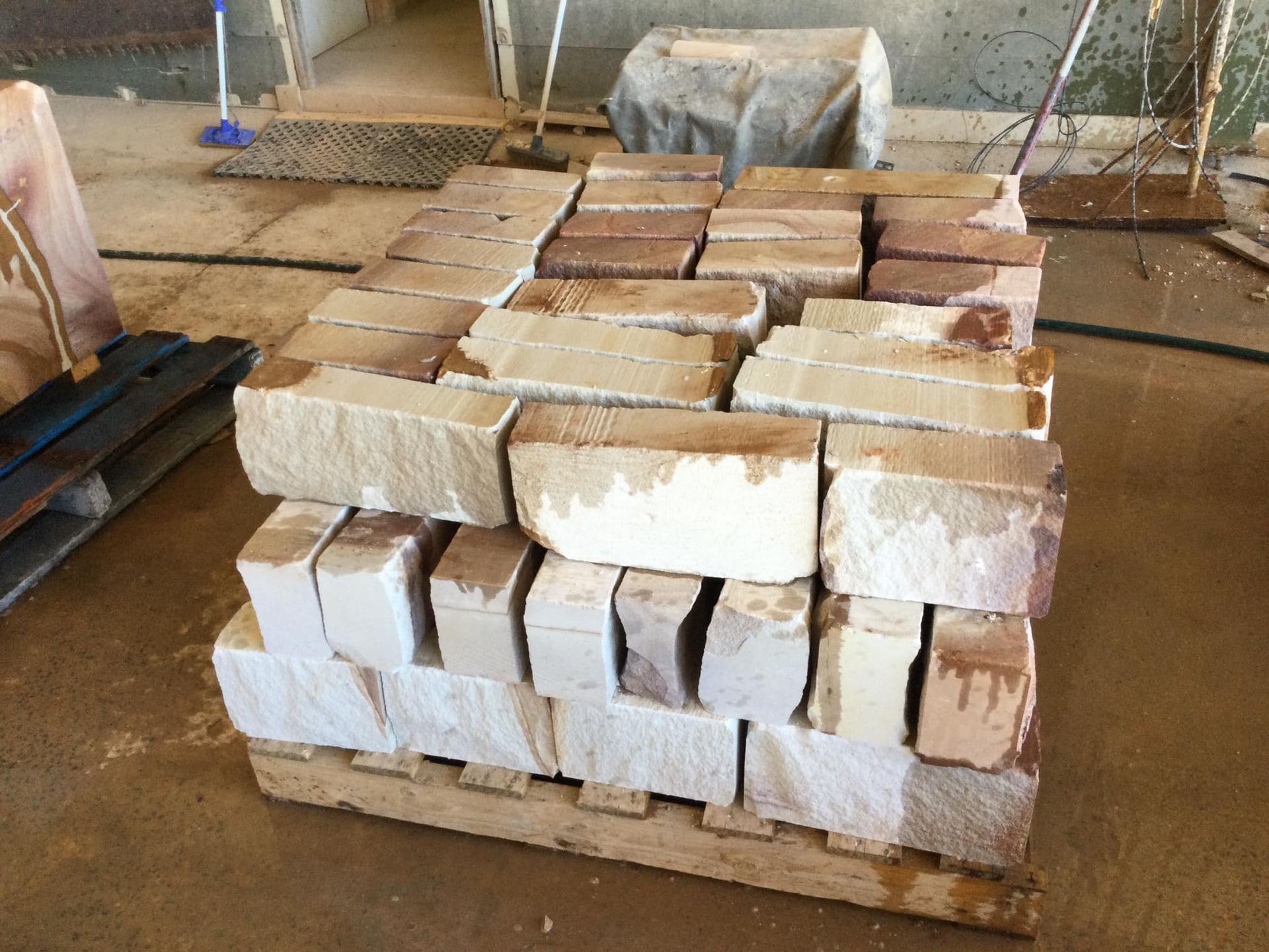 a Stack of Light-colored Bricks Sits on a Wooden Pallet — Australian Sandstone Products In Gatton, QLD.