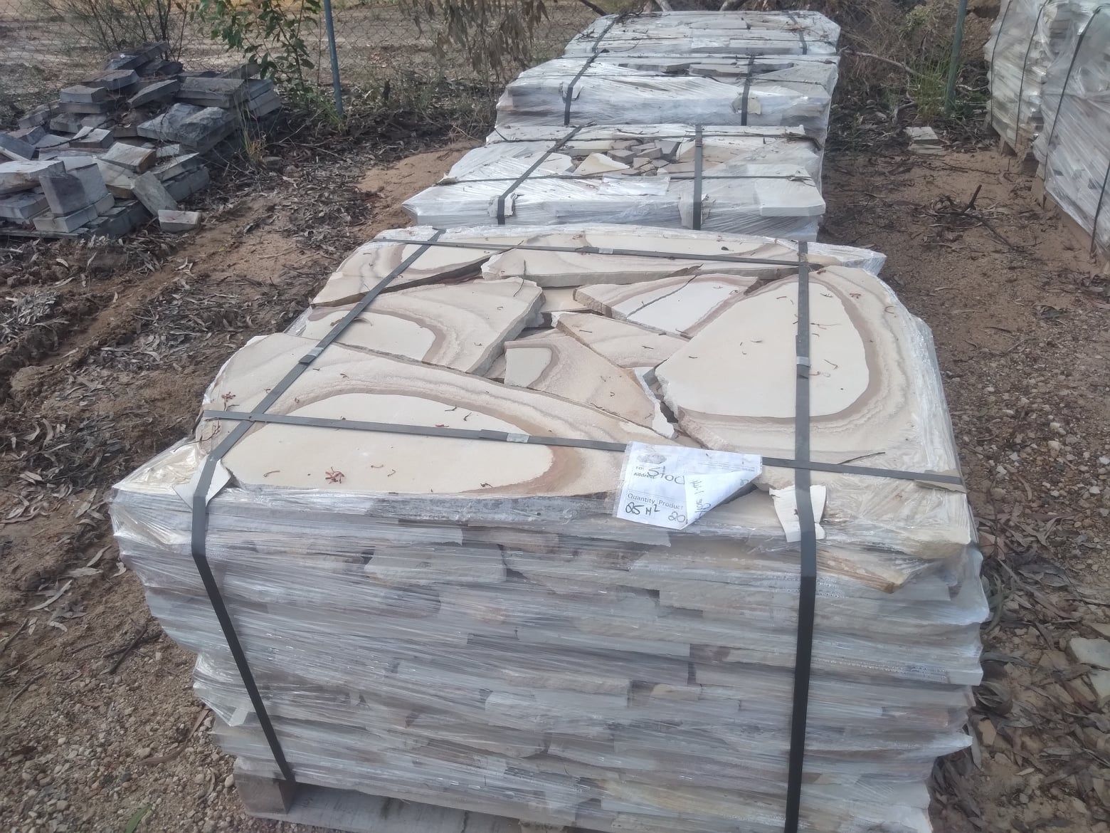 Bundled Flagstone Paving Stones in a Yard — Australian Sandstone Products In Helidon, QLD