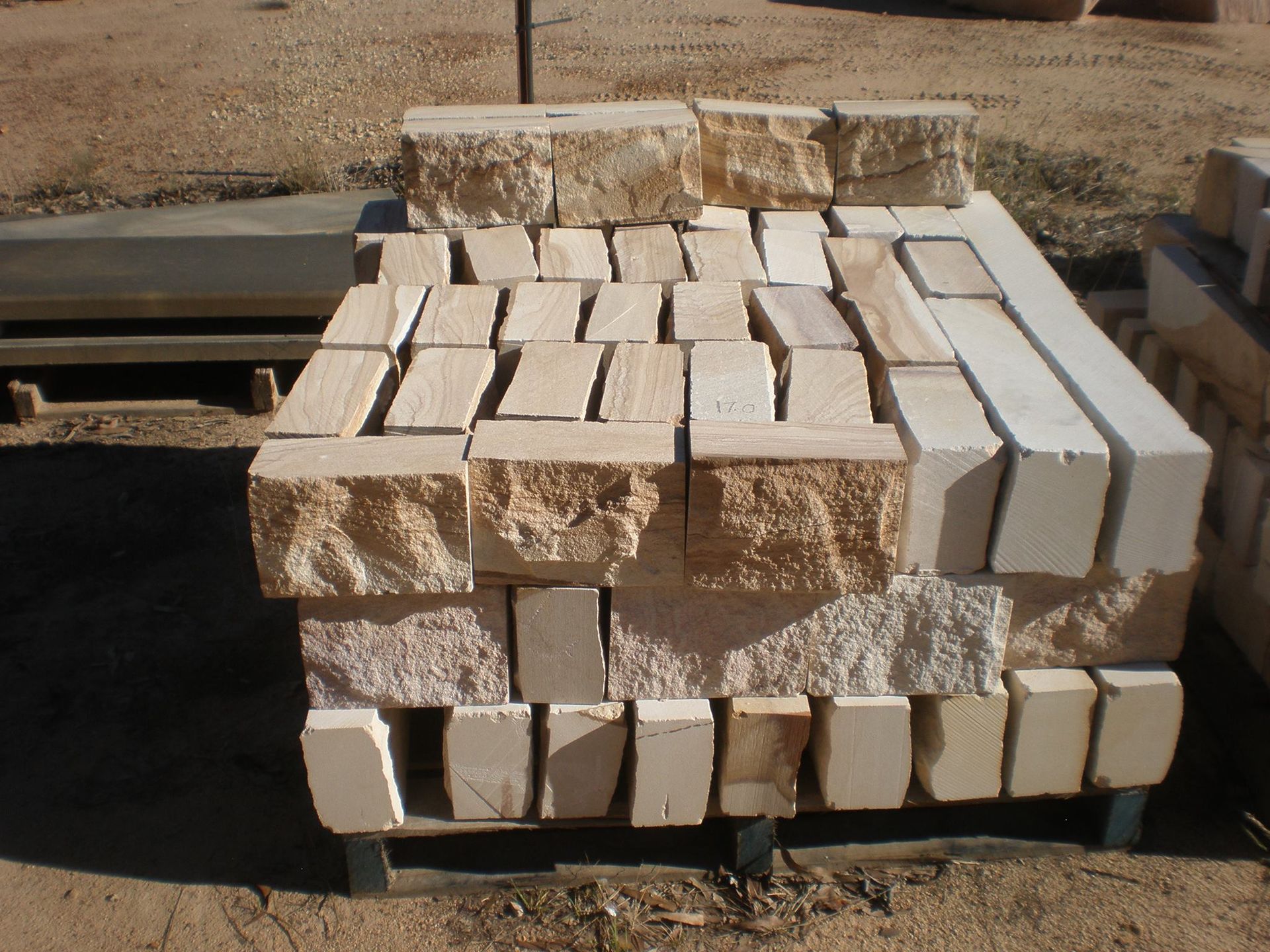 Stack of Light Beige Rectangular Stone Blocks on a Pallet Outdoors — Australian Sandstone Products In Helidon, QLD